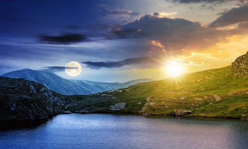 Spring Equinox - day and night time change concept above summer landscape with lake on high altitude. beautiful scenery of fagaras mountain ridge. open view in to the distant peak beneath a clouds with sun and moon
